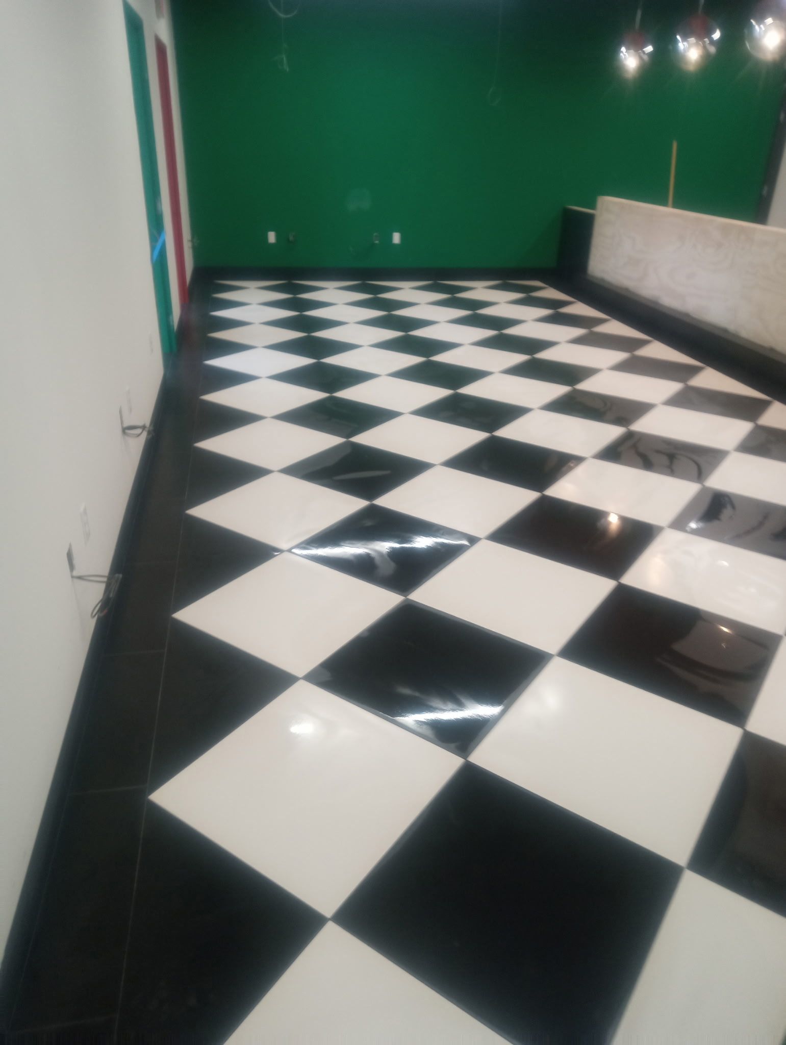 Black and ivory checkerboard tile floor installed in a commercial interior