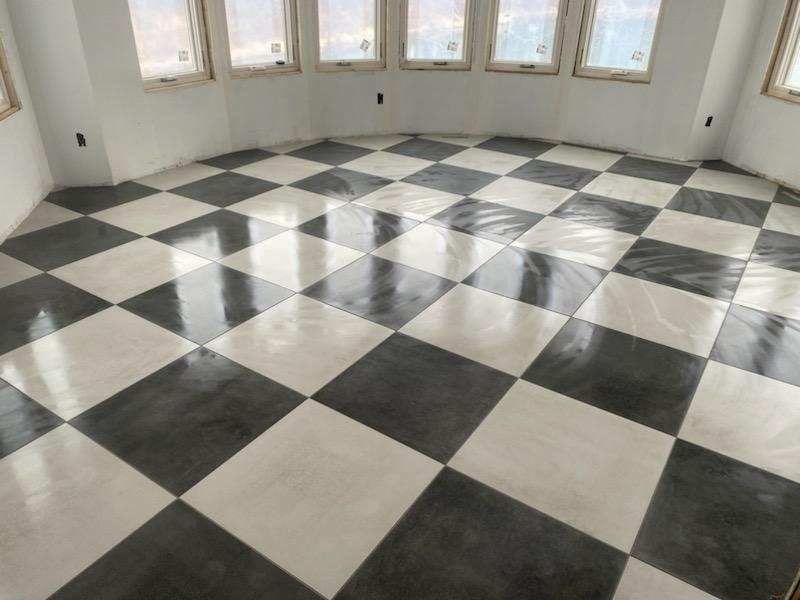 Polished black and white checkerboard tile floor in a bright curved room